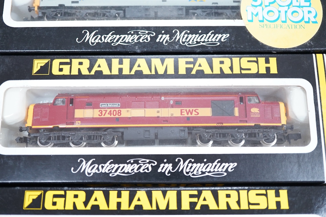 Four boxed Graham Farish N gauge railway Class 37 diesel locomotives; a BR Railfreight, 37 699 (8036), a BR Petroleum Sector, 37 887 (8037), a Mainline, 37055 (803D) and an EWS, 37408 (803E).
